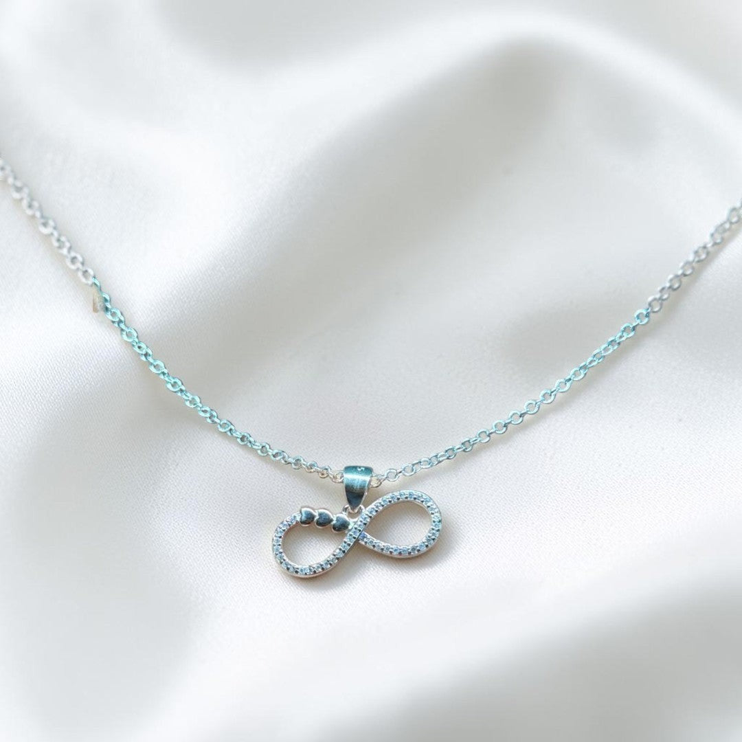 BlingbyAnvika sterling silver infinity necklace with cubic zirconia and heart details. Delicate chain for timeless elegance.