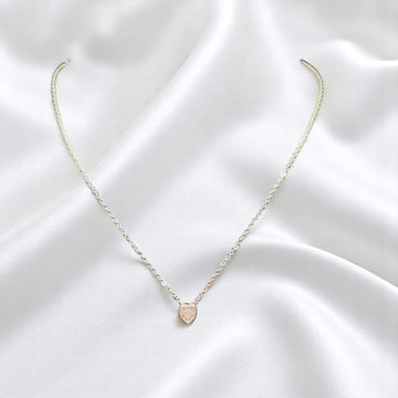 BlingbyAnvika delicate 925 sterling silver heart pendant necklace on a white satin background