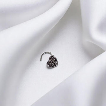 BlingbyAnvika 925 sterling silver heart-shaped nose pin with detailed beaded texture on a white satin background