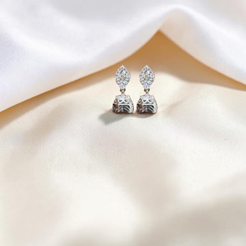 BlingbyAnvika 925 sterling silver jhumka earrings with intricate detailing and small clear stones.