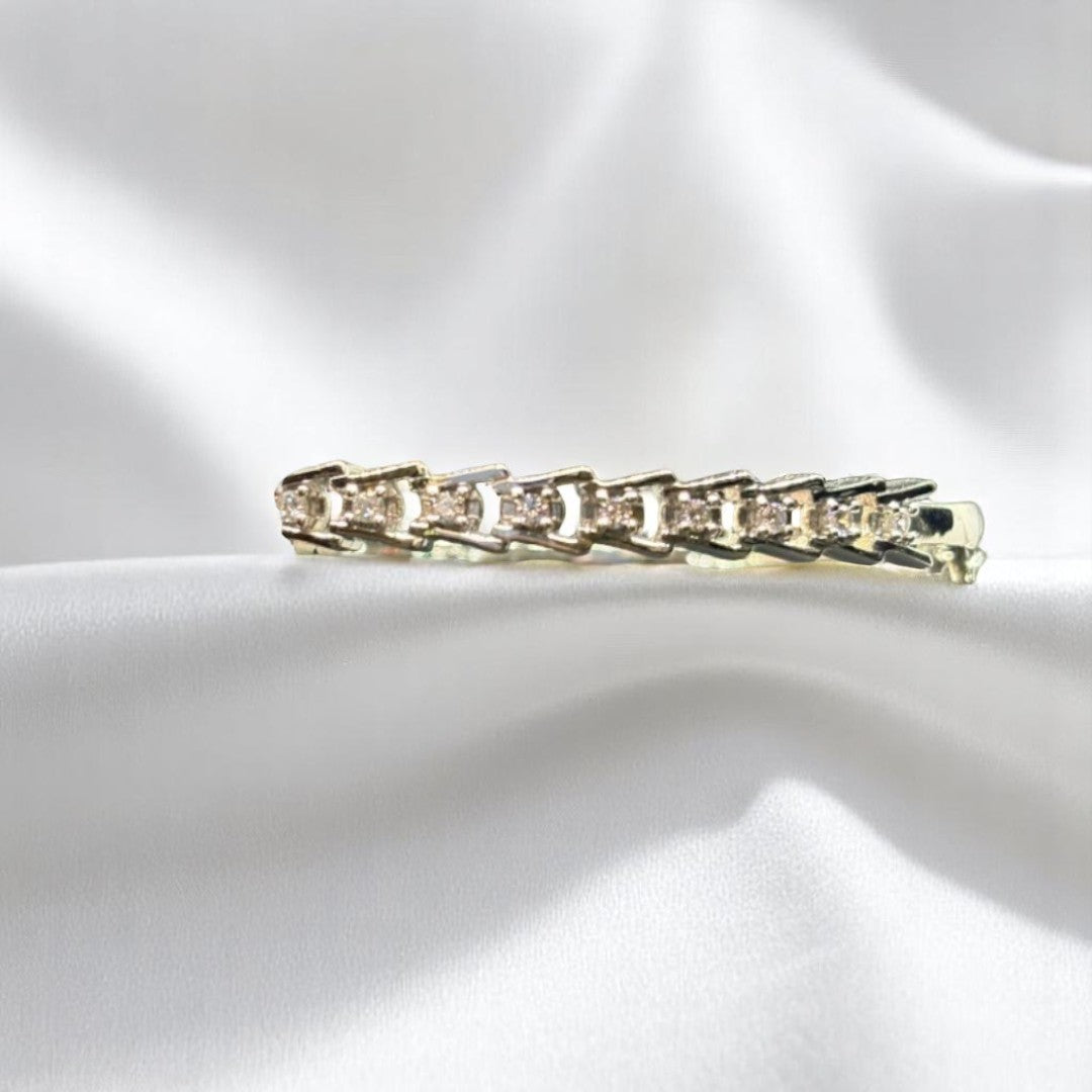 BlingbyAnvika 925 sterling silver kada bracelet with intricate link detailing on a soft white satin fabric background.