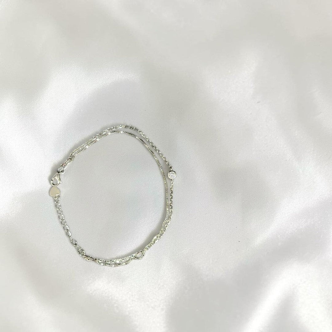 BlingbyAnvika 925 Sterling Silver layered chain bracelet with cubic zirconia accent and heart charm.