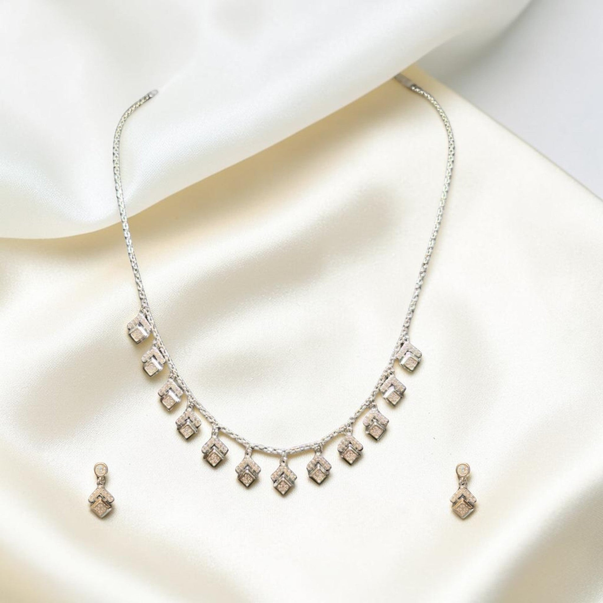 BlingbyAnvika elegant 925 sterling silver necklace and earrings set with diamond-shaped pendants.