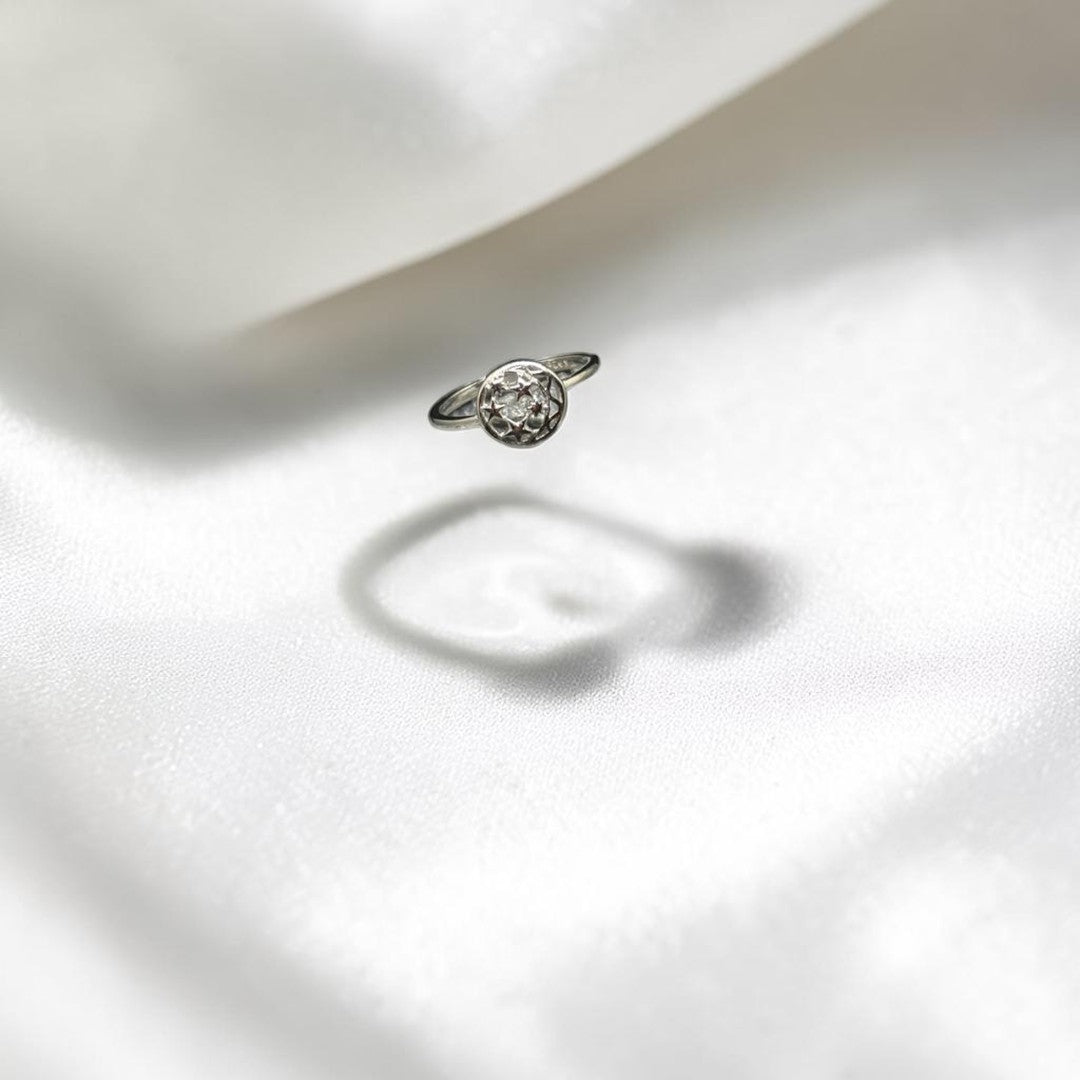 BlingbyAnvika 925 sterling silver ring with circular setting and sparkling stones, vintage charm.