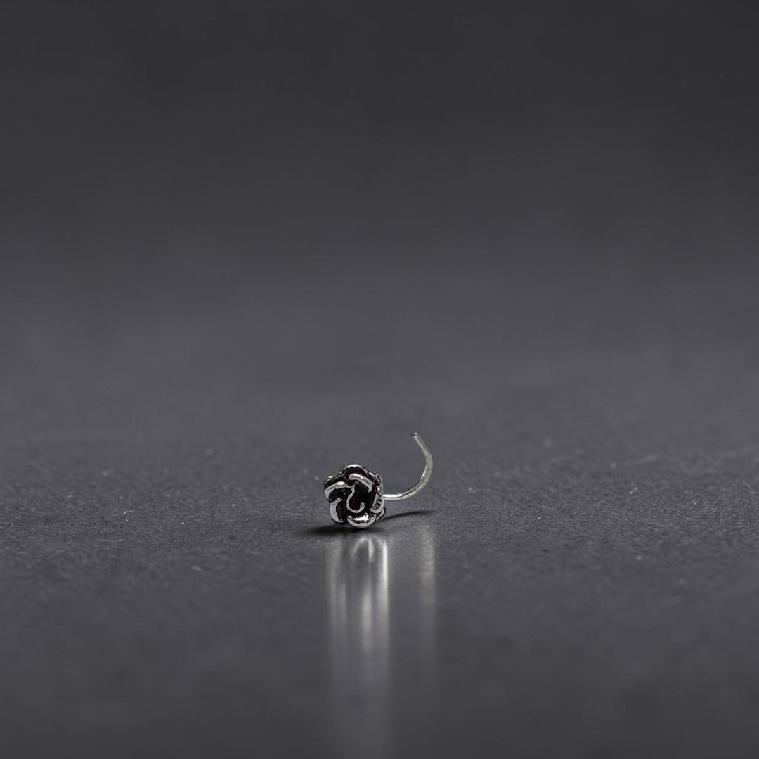 BlingbyAnvika 925 sterling silver nose pin featuring a detailed rose flower design on a white satin background.