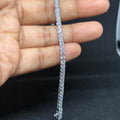 BlingbyAnvika 925 sterling silver tennis bracelet with sparkling stones held against a black background