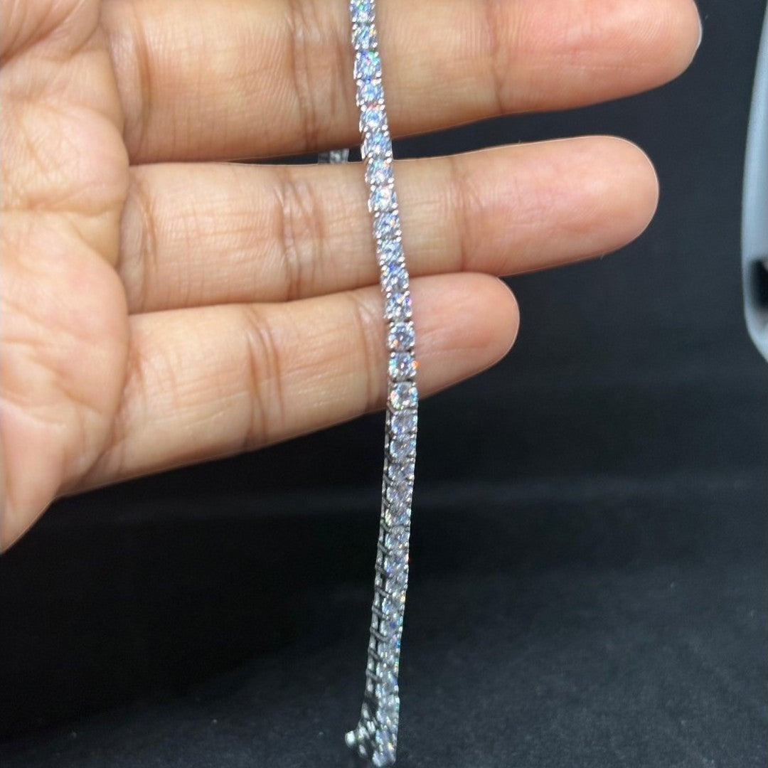 BlingbyAnvika 925 sterling silver tennis bracelet with sparkling stones held against a black background