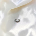 BlingbyAnvika 925 sterling silver nose ring with a twisted rope texture on a soft white satin background.