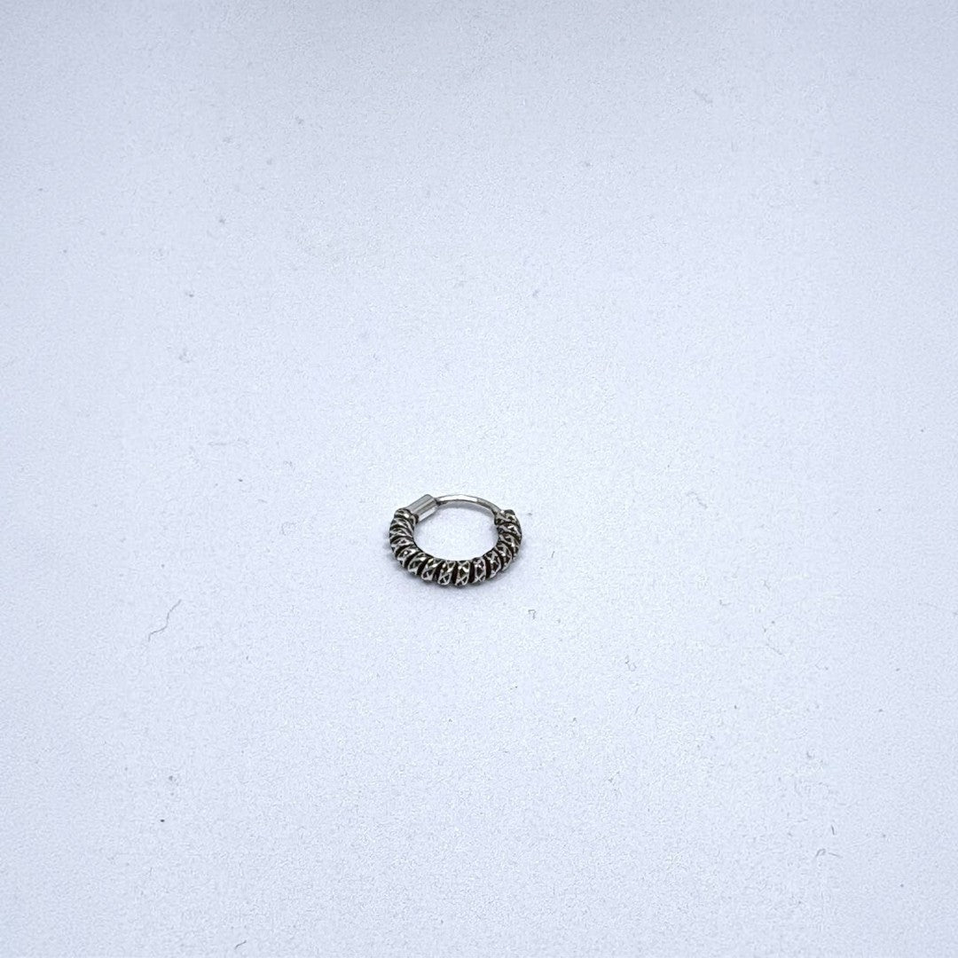 BlingbyAnvika 925 sterling silver nose ring featuring a textured twisted hoop design on a white background.
