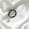 BlingbyAnvika 925 silver baby bracelet with black beads and silver cubes, adjustable pull-string closure.