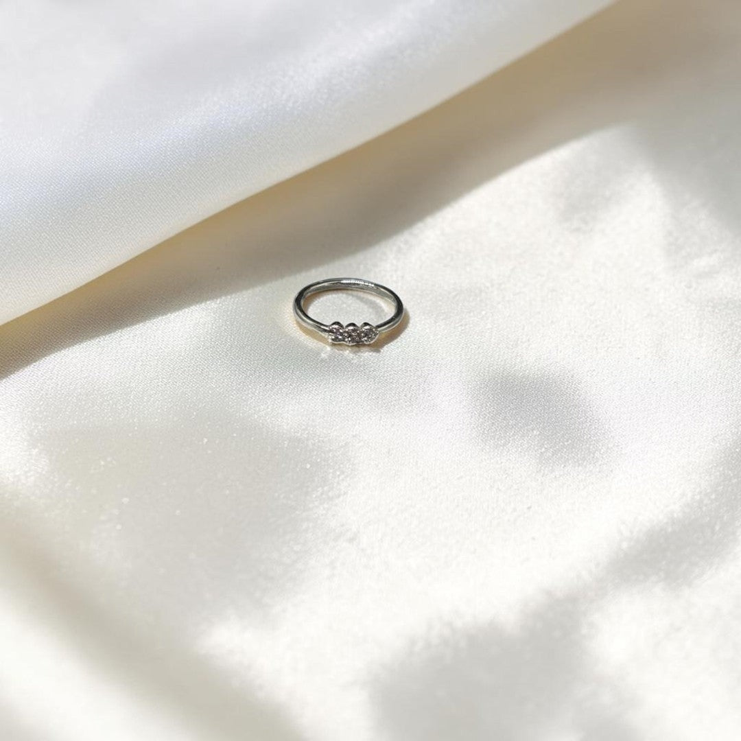 BlingbyAnvika delicate sterling silver ring with three cubic zirconia stones on a minimalist band.