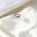 BlingbyAnvika delicate sterling silver ring with three cubic zirconia stones on a minimalist band.