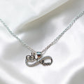 BlingbyAnvika silver pendant with infinity symbol, interlocking rings, and the word 