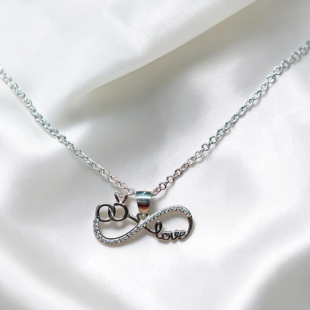 BlingbyAnvika silver pendant with infinity symbol, interlocking rings, and the word "love" adorned with cubic zirconia.