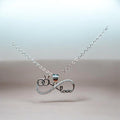 BlingbyAnvika silver pendant with infinity symbol, interlocking rings, and 'love' text, adorned with cubic zirconia.