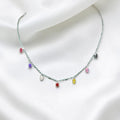 BlingbyAnvika sterling silver necklace with oval-cut colorful gemstones dangling from a fine chain.
