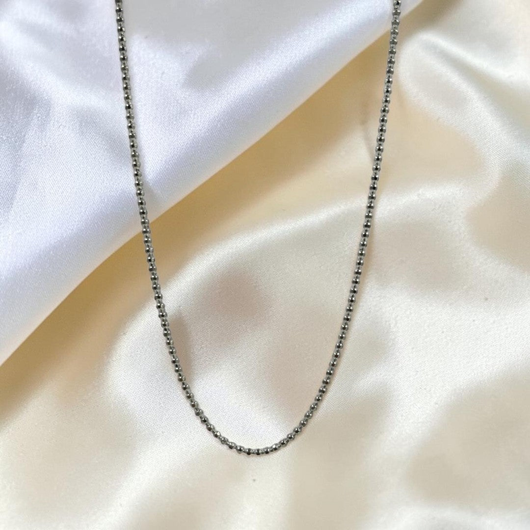 BlingbyAnvika 925 sterling silver ball bead neck chain for men draped over soft white fabric