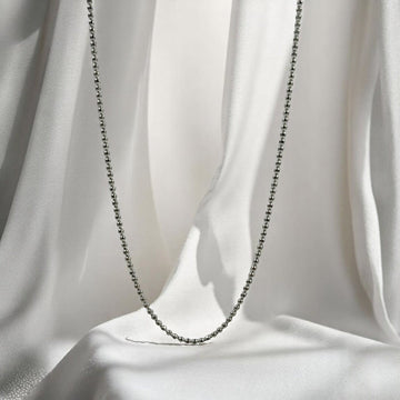 BlingbyAnvika 925 sterling silver ball bead neck chain for men draped over soft white fabric