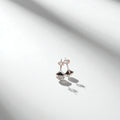 BlingbyAnvika 925 sterling silver triangle stud earrings with black stone and clear crystal accents.