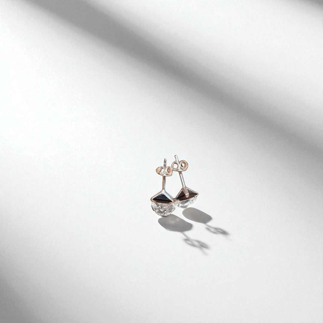 BlingbyAnvika 925 sterling silver triangle stud earrings with black stone and clear crystal accents.