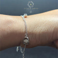 BlingbyAnvika 925 Sterling Silver bracelet with a dainty chain and oval charm encrusted with tiny stones.