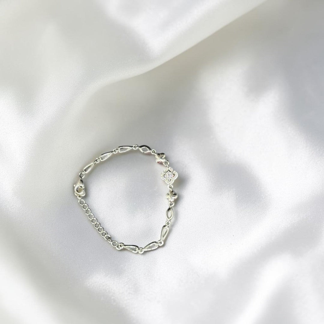 BlingbyAnvika 925 Sterling Silver bracelet with floral charm and cubic zirconia accents. Delicate chain with heart clasp.