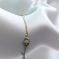 BlingbyAnvika 925 sterling silver delicate charm bracelet with oval pendant encrusted with tiny stones.