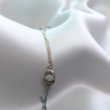 BlingbyAnvika 925 sterling silver delicate charm bracelet with oval pendant encrusted with tiny stones.