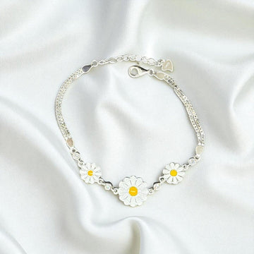 BlingbyAnvika 925 silver daisy charm bracelet with white and yellow enamel flowers and clear crystal accents.