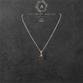 BlingbyAnvika 925 sterling silver necklace with a single, faceted dark brown stone pendant, accented with small clear stones.