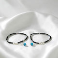 BlingbyAnvika 925 sterling silver anklets with black thread, colorful beads, and blue evil eye charms for protection.