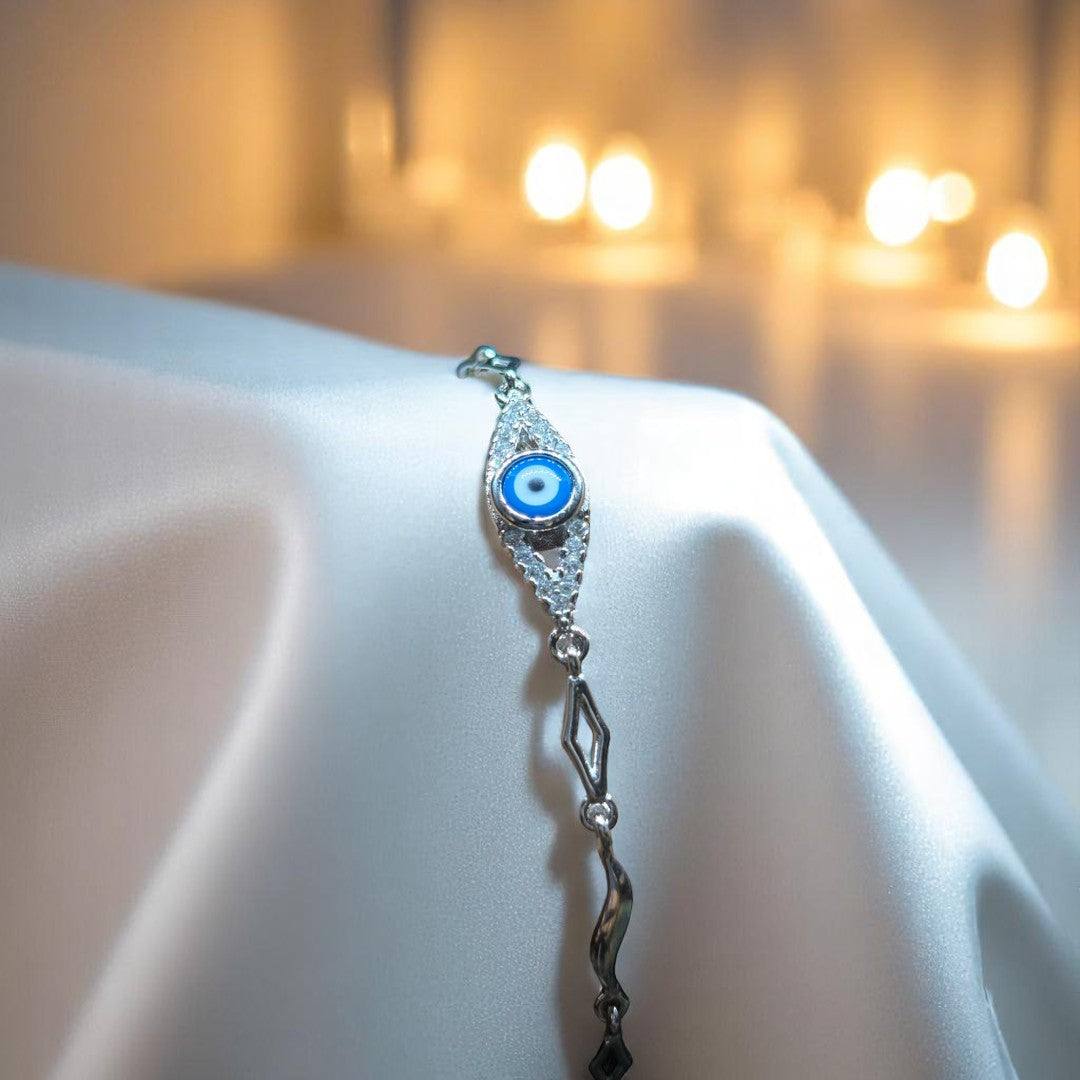BlingbyAnvika 925 silver bracelet with blue and white evil eye charm, cubic zirconia accents, and geometric links.