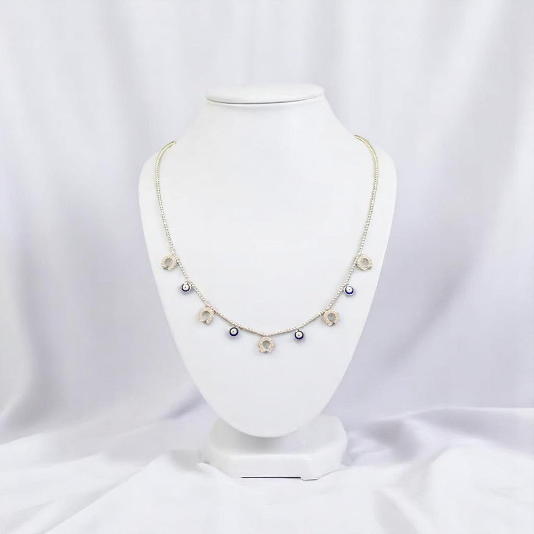 BlingbyAnvika sterling silver short necklace with dangling evil eye and horseshoe charms.