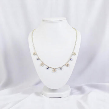 BlingbyAnvika sterling silver short necklace with dangling evil eye and horseshoe charms.