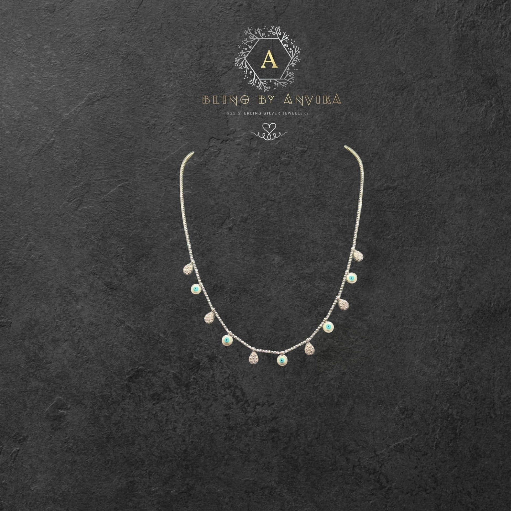 BlingbyAnvika sterling silver short necklace with dangling evil eye and crystal charms.