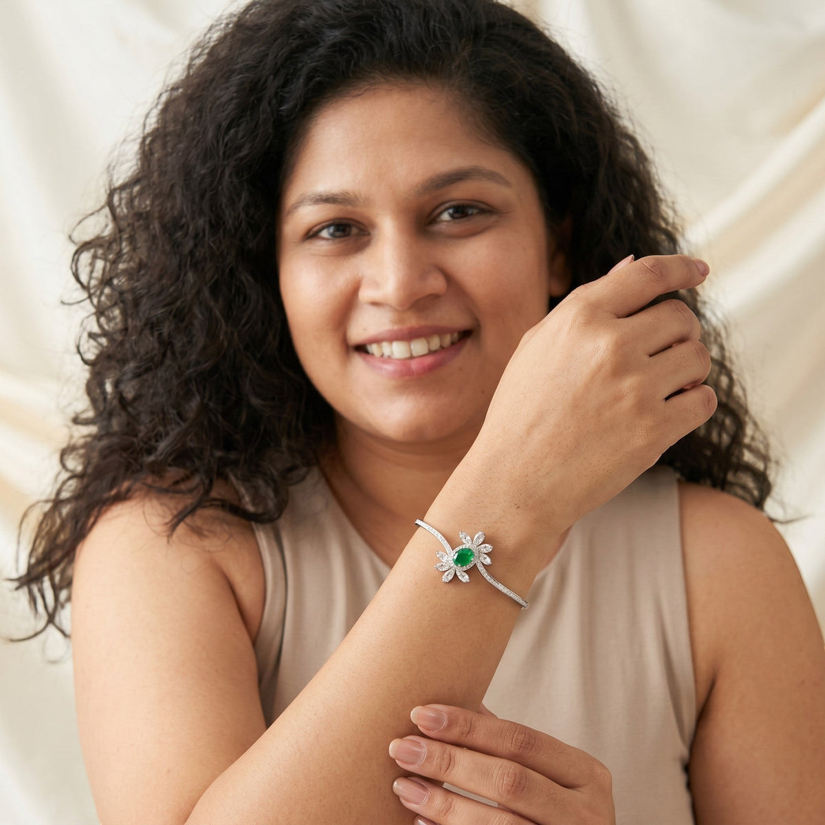 BlingbyAnvika 925 silver floral bracelet with a central green stone and white crystal petals worn by a smiling woman