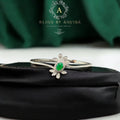 BlingbyAnvika 925 silver floral bracelet featuring a central oval green stone surrounded by marquise-cut white crystals.