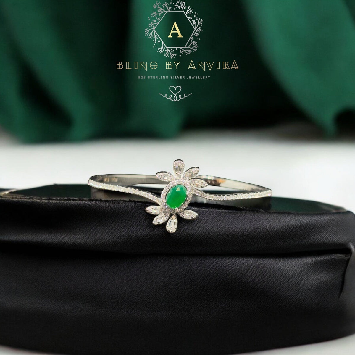 BlingbyAnvika 925 silver floral bracelet featuring a central oval green stone surrounded by marquise-cut white crystals.