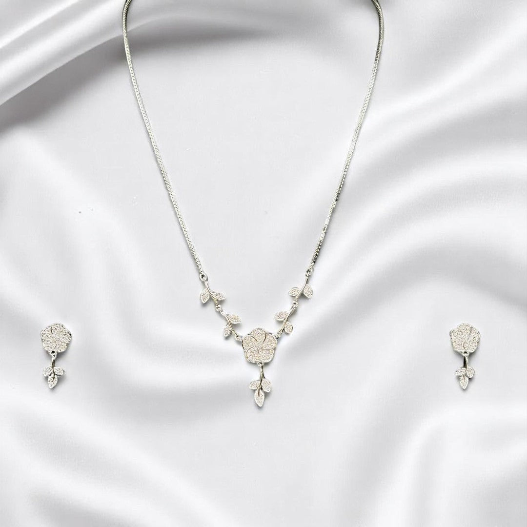 BlingbyAnvika 925 sterling silver floral necklace and matching stud earrings set on a white satin background.
