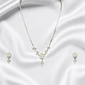 BlingbyAnvika 925 sterling silver floral necklace and matching stud earrings set on a white satin background