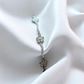 BlingbyAnvika 925 silver link bracelet featuring delicate floral motifs and shimmering stones on white satin fabric.