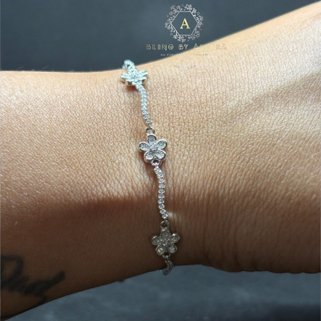 BlingbyAnvika 925 silver link bracelet featuring delicate floral motifs with shimmering stones on a wrist