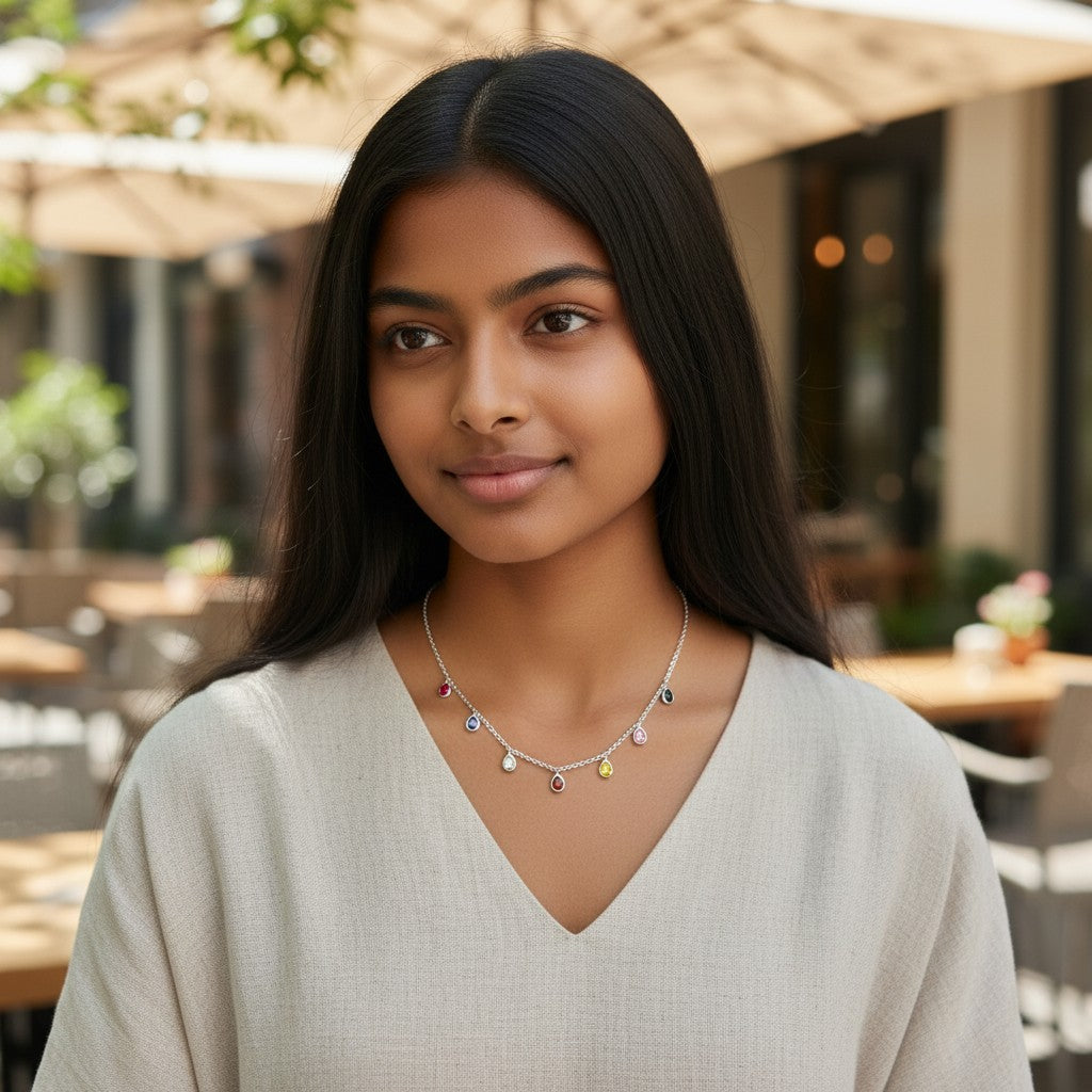 BlingbyAnvika sterling silver necklace with multiple colorful teardrop cubic zirconia gems on a delicate chain.