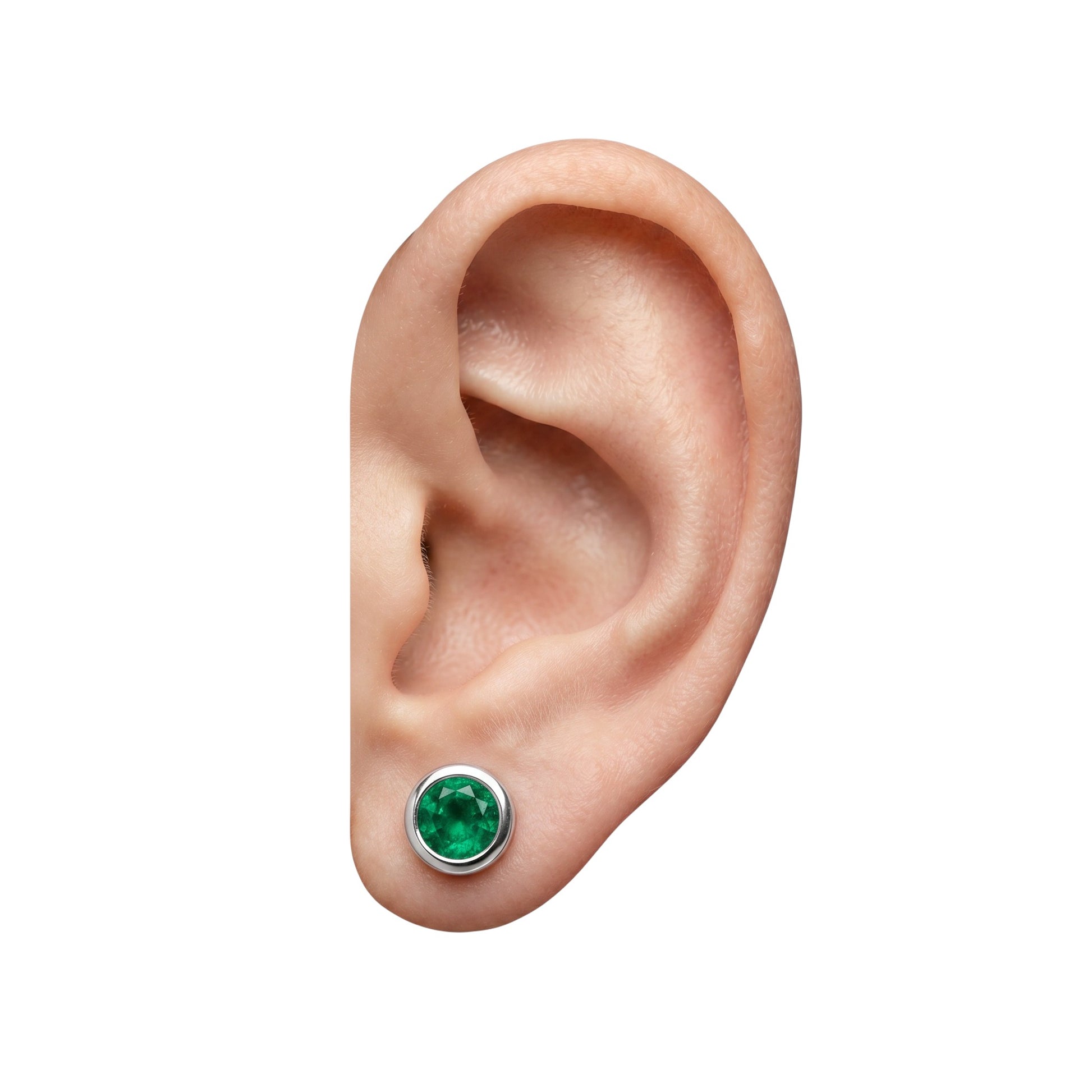 BlingbyAnvika 925 sterling silver stud earrings featuring a vibrant round green stone worn on an earlobe.