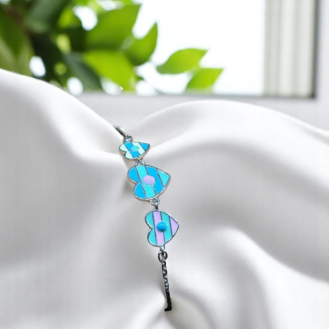BlingbyAnvika 925 sterling silver bracelet with three blue and pink striped enamel heart charms.