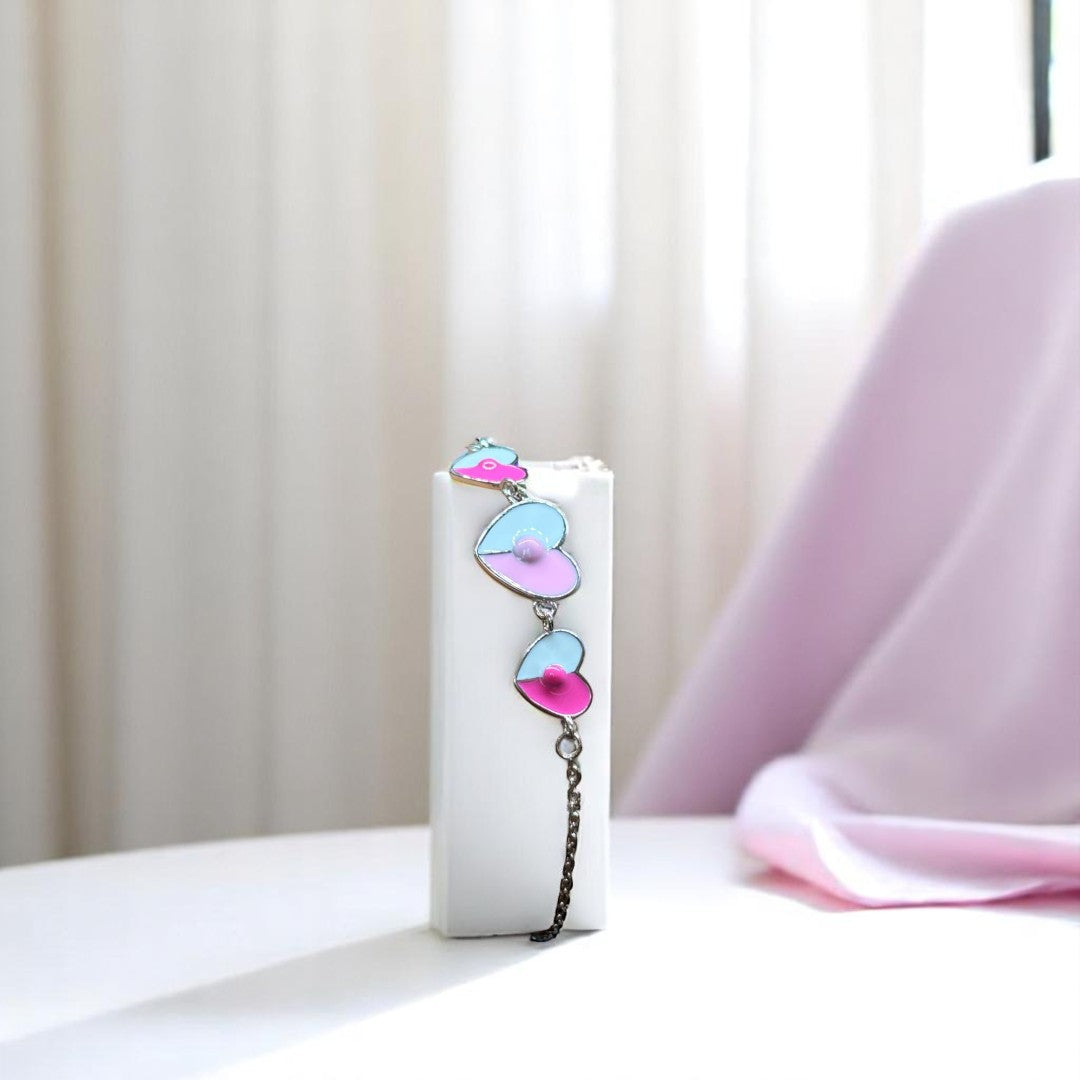 BlingbyAnvika 925 sterling silver bracelet with pastel blue and pink enamel heart charms and a delicate chain.