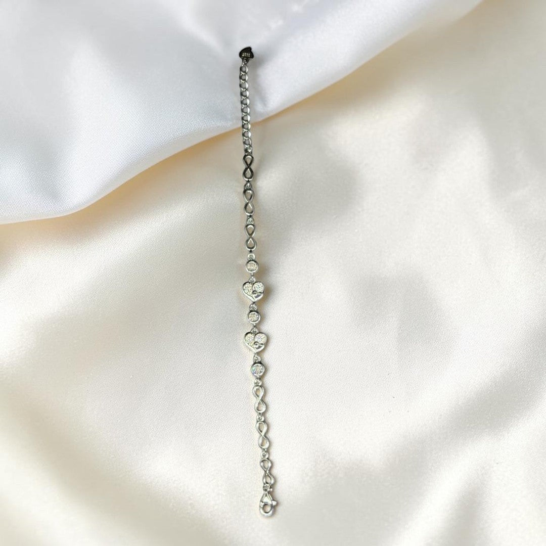 BlingbyAnvika 925 Sterling Silver bracelet with cubic zirconia heart charms and infinity links.