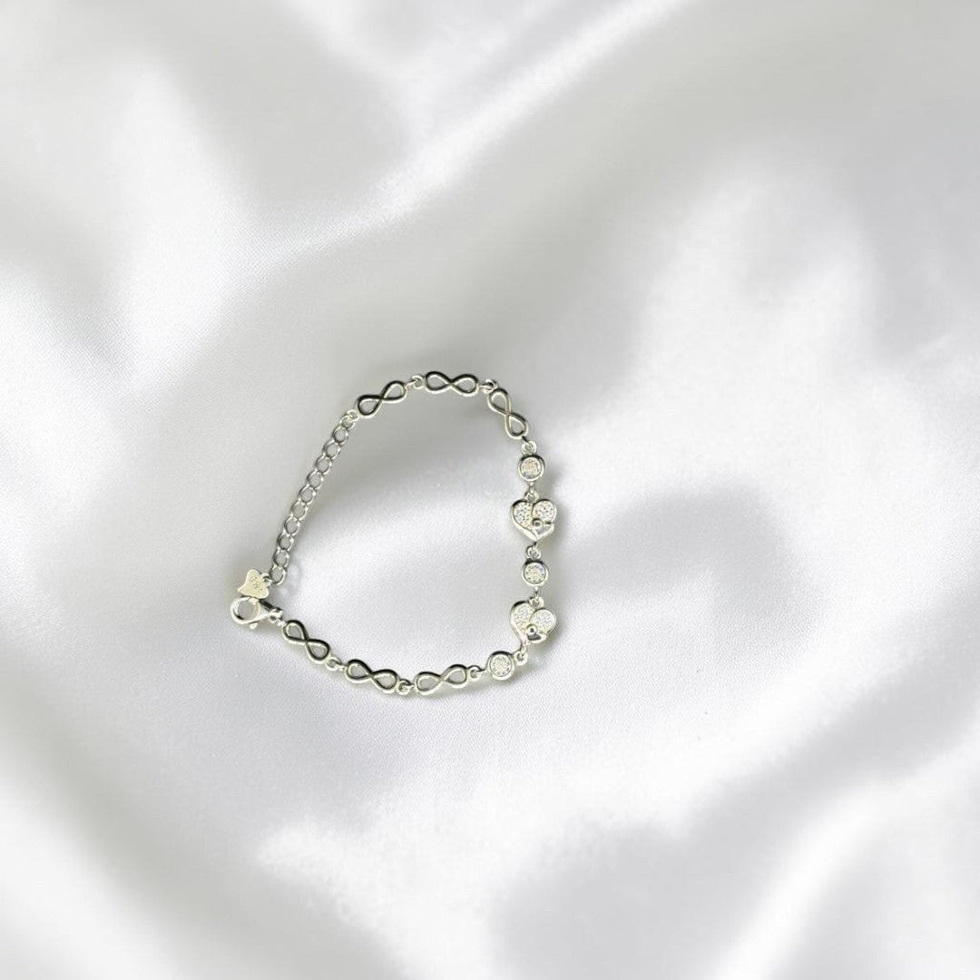BlingbyAnvika 925 Sterling Silver bracelet with cubic zirconia heart charms and infinity links.