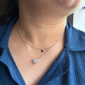 BlingbyAnvika layered sterling silver necklace with a large crystal-encrusted heart pendant and a small black heart charm.