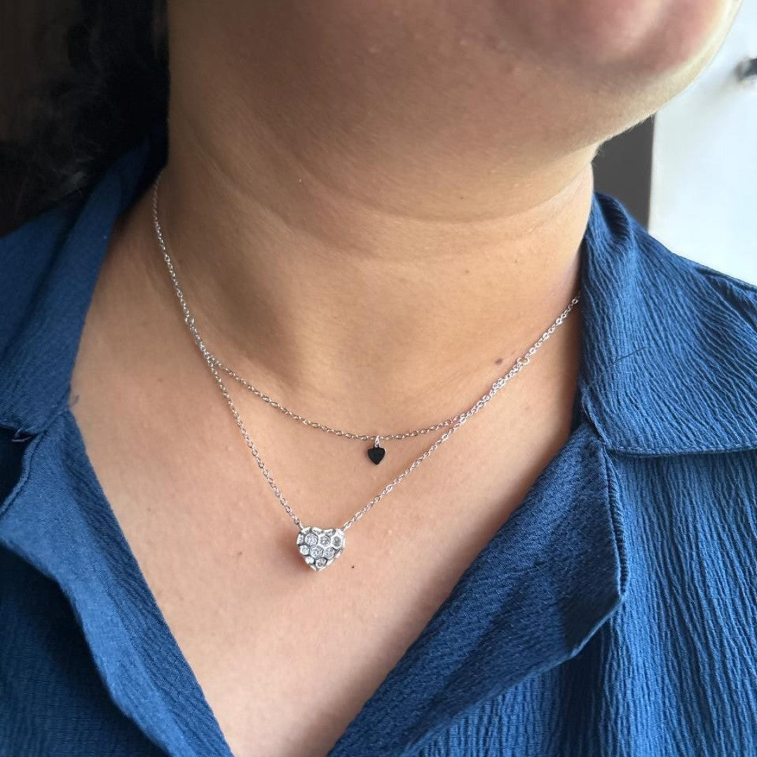 BlingbyAnvika layered sterling silver necklace with a large crystal-encrusted heart pendant and a small black heart charm.